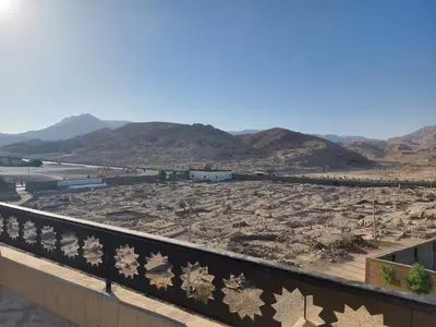 a view of a desert with mountains in the background at Carter Guesthouse Luxor 1 in ‘Ezbet Abu Ḥabashi