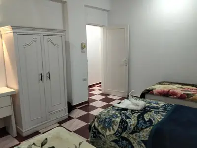 a bedroom with a bed and a dresser at Djorff Guest House in Luxor