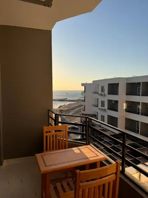 a balcony with a table and chairs and a view of the beach at Hurghada seaview apartment in Hurghada
