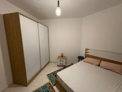 a bedroom with a bed and a cabinet in it at Hurghada seaview apartment in Hurghada