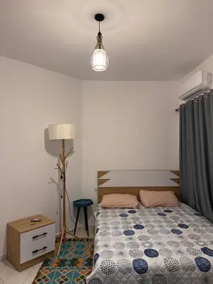 a bedroom with a bed and a lamp at Hurghada seaview apartment in Hurghada