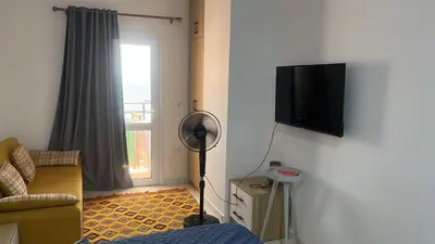 a living room with a flat screen tv on a wall at Cosy Hurghada Apartments in Hurghada