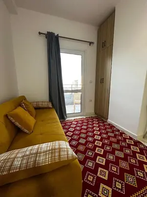 a bedroom with a bed and a large window at Cosy Hurghada Apartments in Hurghada