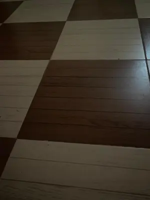 a wooden floor with brown and white floors at LXR Oasis in Luxor