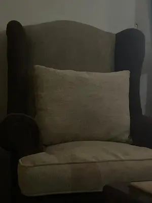 a chair with a pillow on top of it at LXR Oasis in Luxor