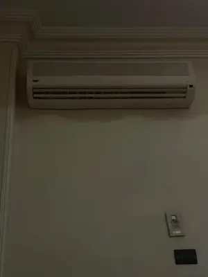 a white air conditioner on the wall of a room at LXR Oasis in Luxor