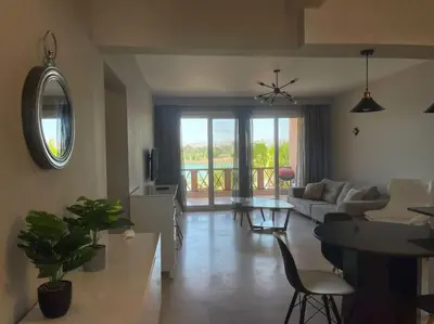 a living room with a couch and a table at The Sunset Heaven - 2 bedrooms - Golf Steigenberger, El Gouna in Hurghada