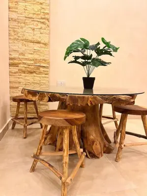 a table made out of a tree stump with a potted plant at Komfortowy apartament na dachu w sercu miasta in Hurghada