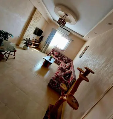 a living room with a couch and a table at Komfortowy apartament na dachu w sercu miasta in Hurghada