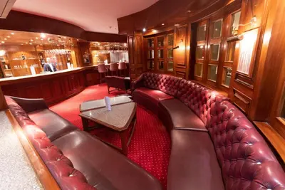 a train car with a leather couch and a bar at Aladdin Beach Resort in Hurghada