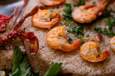 a close up of shrimp on rice on a plate at Aladdin Beach Resort in Hurghada