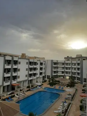a view of a hotel with a swimming pool and buildings at SKY EL Gandoul Wohnung Hurghada in Hurghada