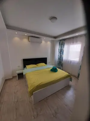 a bedroom with a bed with a yellow blanket at SKY EL Gandoul Wohnung Hurghada in Hurghada