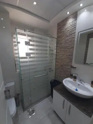 a bathroom with a shower and a sink and a toilet at SKY EL Gandoul Wohnung Hurghada in Hurghada