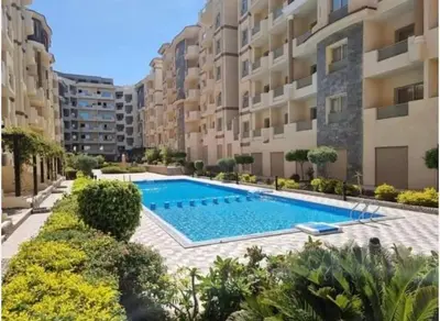 an apartment with a swimming pool in a building at Chic Studio with Modern Comforts in Hurghada