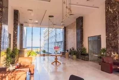 a lobby with a table and chairs in a building at Scandic sea view in Hurghada
