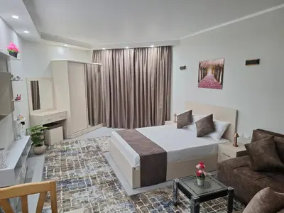 a bedroom with a bed and a couch in a room at Scandic sea view in Hurghada