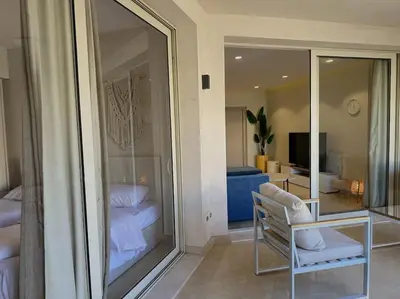 a room with a room with a glass wall at Chic 3BR Ground Free Beach & Pool access at Mangroovy in Hurghada
