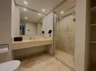 a bathroom with a shower and a toilet and a sink at Chic 3BR Ground Free Beach & Pool access at Mangroovy in Hurghada