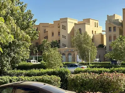 a group of cars parked in front of a building at Chic 3BR Ground Free Beach & Pool access at Mangroovy in Hurghada