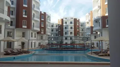 a swimming pool in the middle of a apartment complex at Stunning Rooftop 1 Bed Apartment in Hurghada