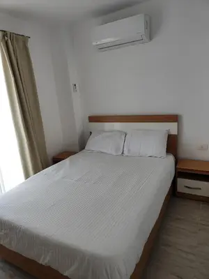 a bedroom with a bed with white sheets and a window at Stunning Rooftop 1 Bed Apartment in Hurghada