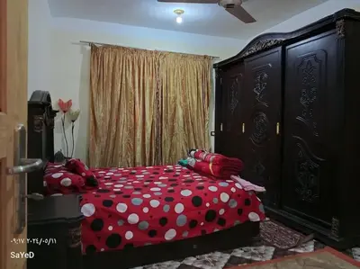 a bedroom with a red bed with polka dot sheets at SaYeD guest house in Dâbûb