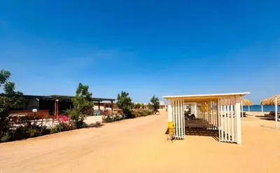 a white shelter on a beach with the ocean at Princess resort luxury G05 in Hurghada