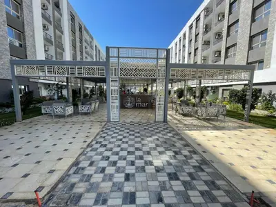 a pavilion with tables and chairs in front of buildings at Fanadir bay resort in Hurghada