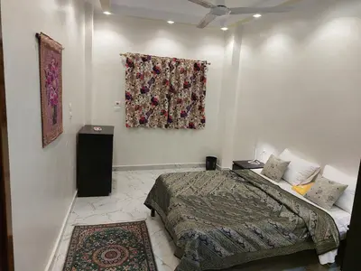 a bedroom with a bed and a painting on the wall at Carter Guesthouse Luxor 3 in Al Karnak