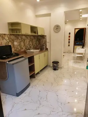 a kitchen with a marble floor and a counter top at Carter Guesthouse Luxor 3 in Al Karnak