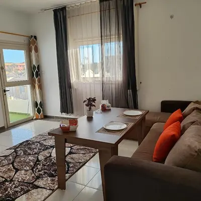 a living room with a couch and a table at Almina Apartments - Come and relax with us in style in Hurghada