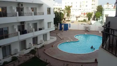 a swimming pool in the middle of a building at Almina Apartments - Come and relax with us in style in Hurghada