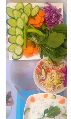 a tray of vegetables and a plate of salad at elephantine nile view house in Aswan
