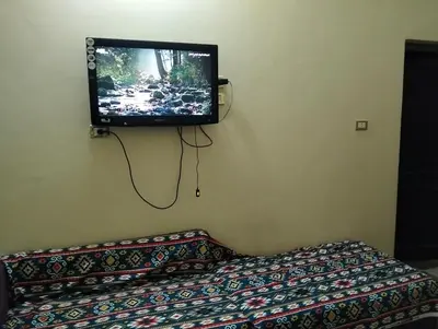 a flat screen tv on the corner of a room at elephantine nile view house in Aswan