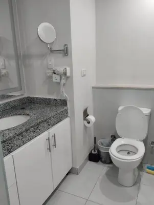 a white bathroom with a toilet and a sink at scandic in Hurghada