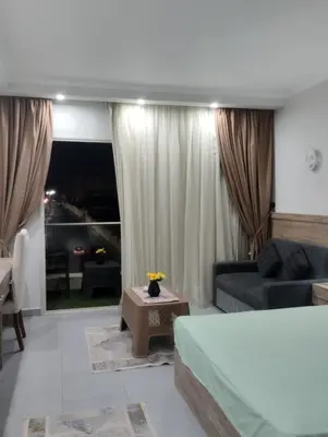 a living room with a bed and a couch at scandic in Hurghada