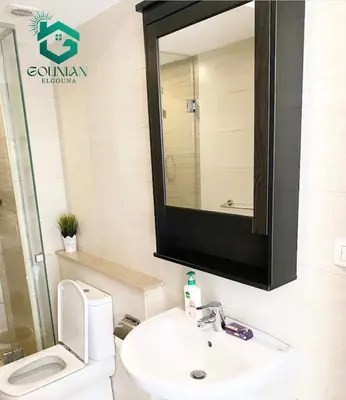 a bathroom with a sink and a toilet and a mirror at El Gouna -G-cribs B6 in El Gouna