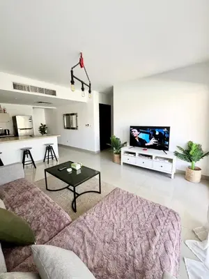 a living room with a couch and a tv at El Gouna -G-cribs B6 in El Gouna