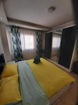 a large bed in a bedroom with a large mirror at Wohnung SKY EL Gandoul in Hurghada