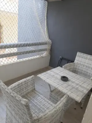 a table and two chairs and a table and a table at Wohnung SKY EL Gandoul in Hurghada