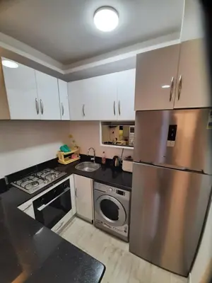 a kitchen with a stainless steel refrigerator and a dishwasher at Wohnung SKY EL Gandoul in Hurghada
