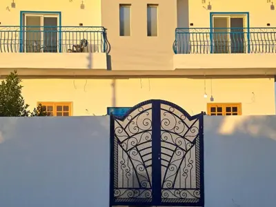 a gate in front of a building with windows at Al Hayat house in Luxor