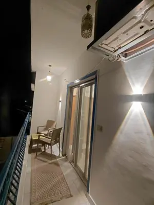 a room with two chairs and a staircase with a window at Al Hayat house in Luxor