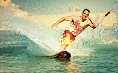 a man on a surfboard in the water at Luxury Stays in Waterside El Gouna in Hurghada