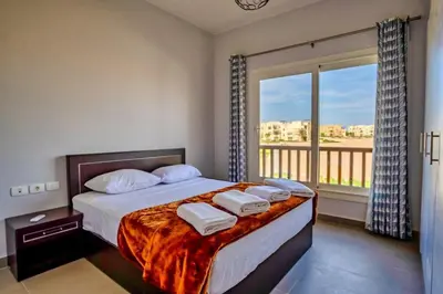 a bedroom with a bed and a large window at Luxury Stays in Waterside El Gouna in Hurghada