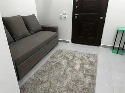 a couch in a living room with a rug and a door at scandic resort in Hurghada