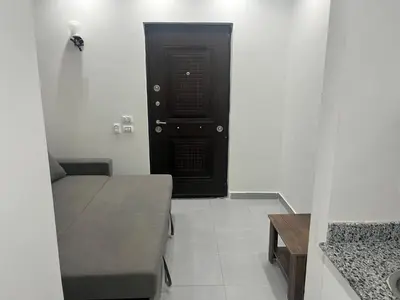 a room with a black door and a couch and a table at scandic resort in Hurghada