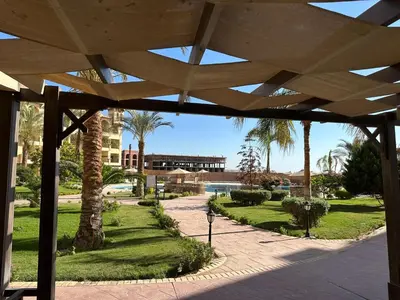 a view of a park with palm trees and a building at Al Saraya Sahl Hasheesh by Peaks in Hurghada