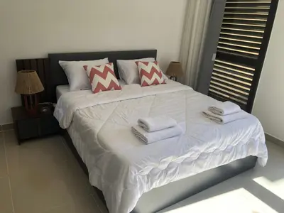 a bedroom with a large white bed with towels on it at G cribs B15 in Hurghada